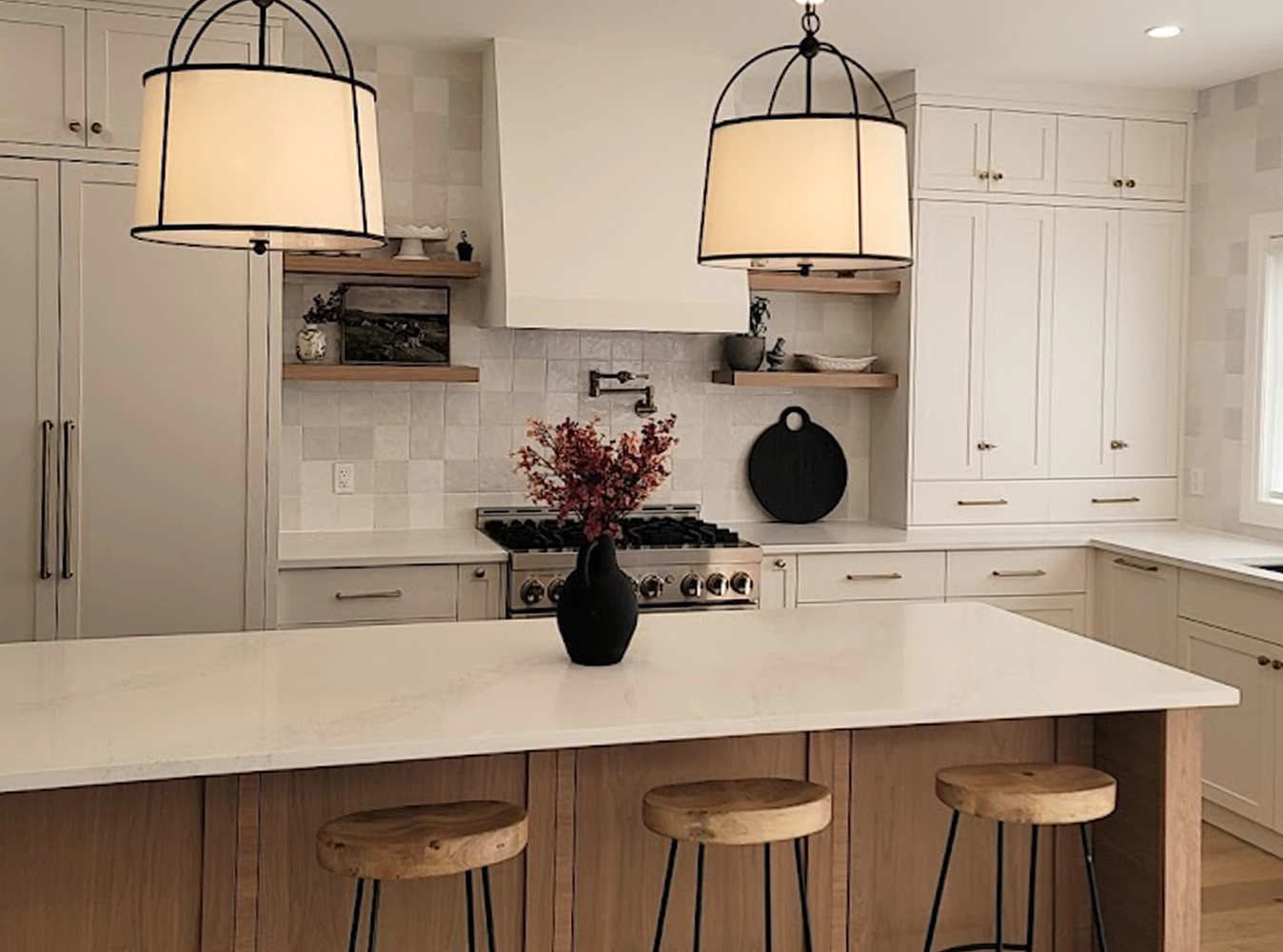 Transitional kitchen with wood island, cage pendants and white shaker cabinetry
