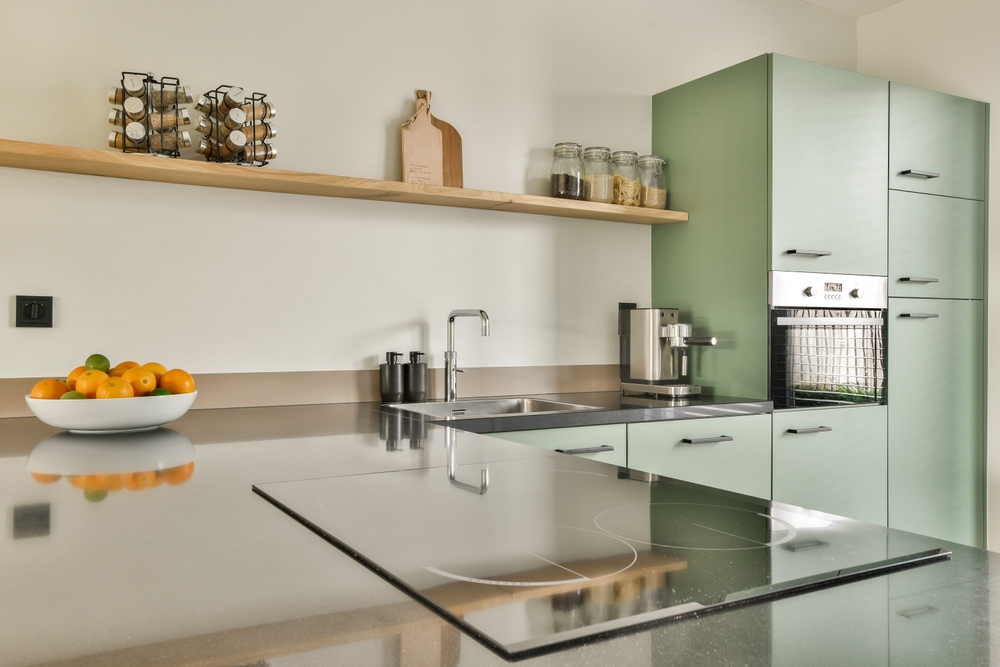 Custom luxury kitchen cabinetry with green slab doors and wood accents