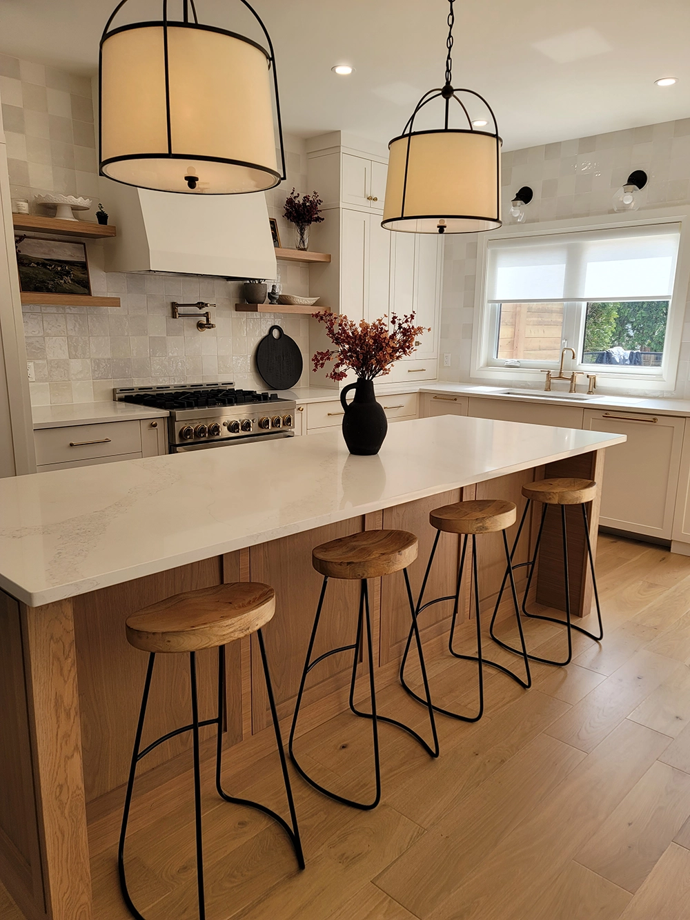 Custom kitchen with white shaker cabinetry and wood island