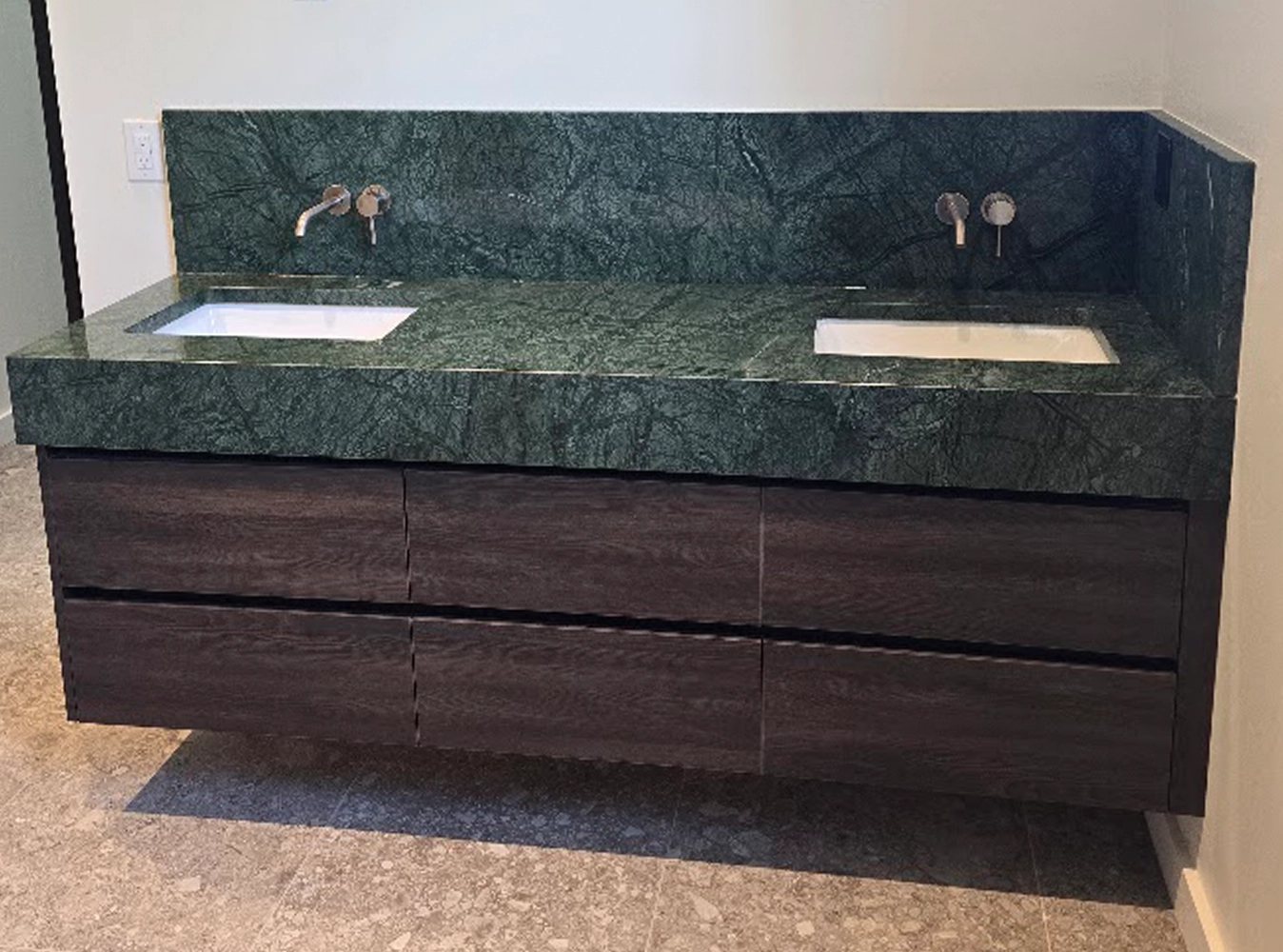 Contemporary floating double vanity with dark wood and dramatic green marble countertop