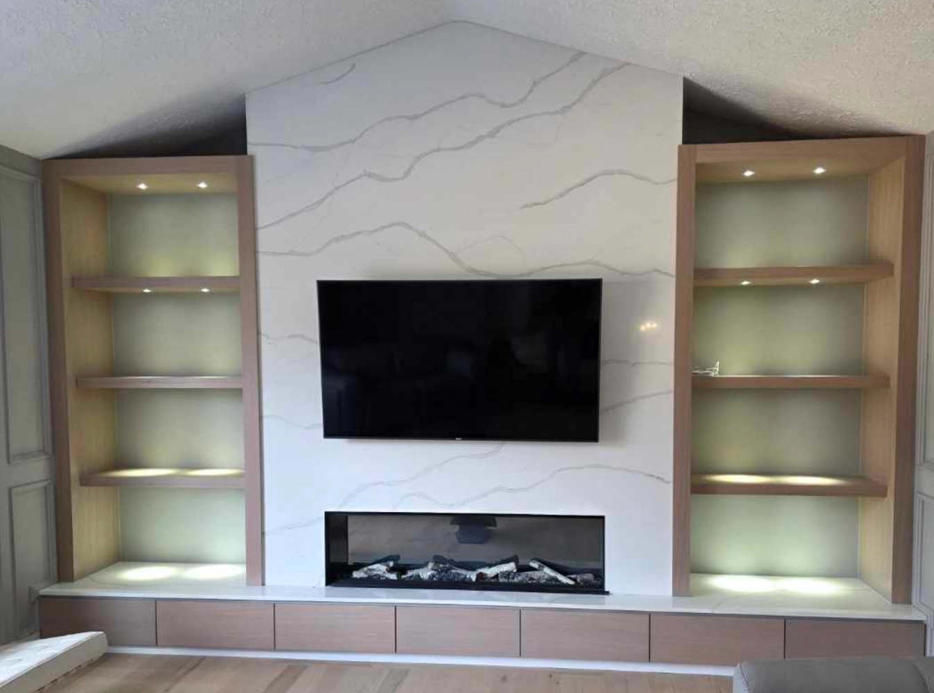Custom built-in entertainment wall with fireplace and shelving