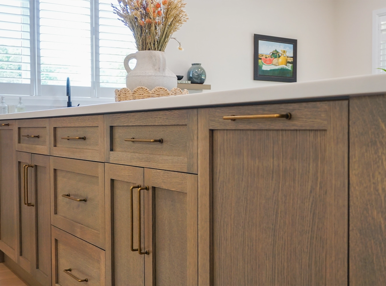 Custom oak kitchen cabinetry with antique brass hardware