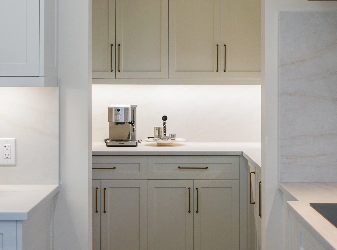 Custom kitchen butler pantry with sage cabinetry and brass hardware