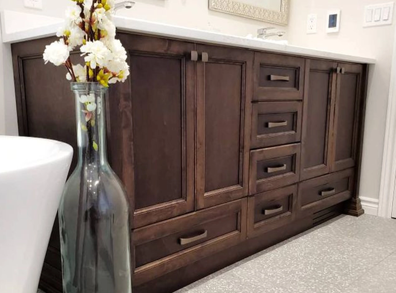 Custom dark wood bathroom vanity with marble countertop